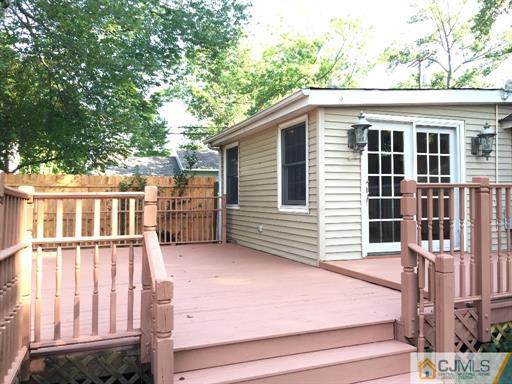 266 Raritan Boulevard Old Bridge, NJ 07735 - Photo 11 of 12 a view of a house with a small yard and wooden fence