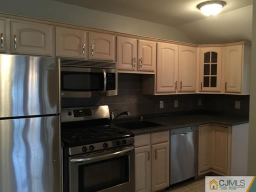 266 Raritan Boulevard Old Bridge, NJ 07735 - Photo 6 of 12 a kitchen with granite countertop a refrigerator stove and microwave