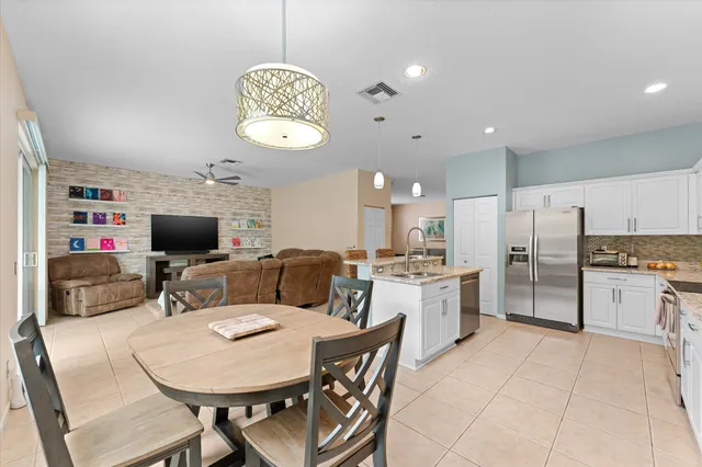 a large kitchen with a table and chairs