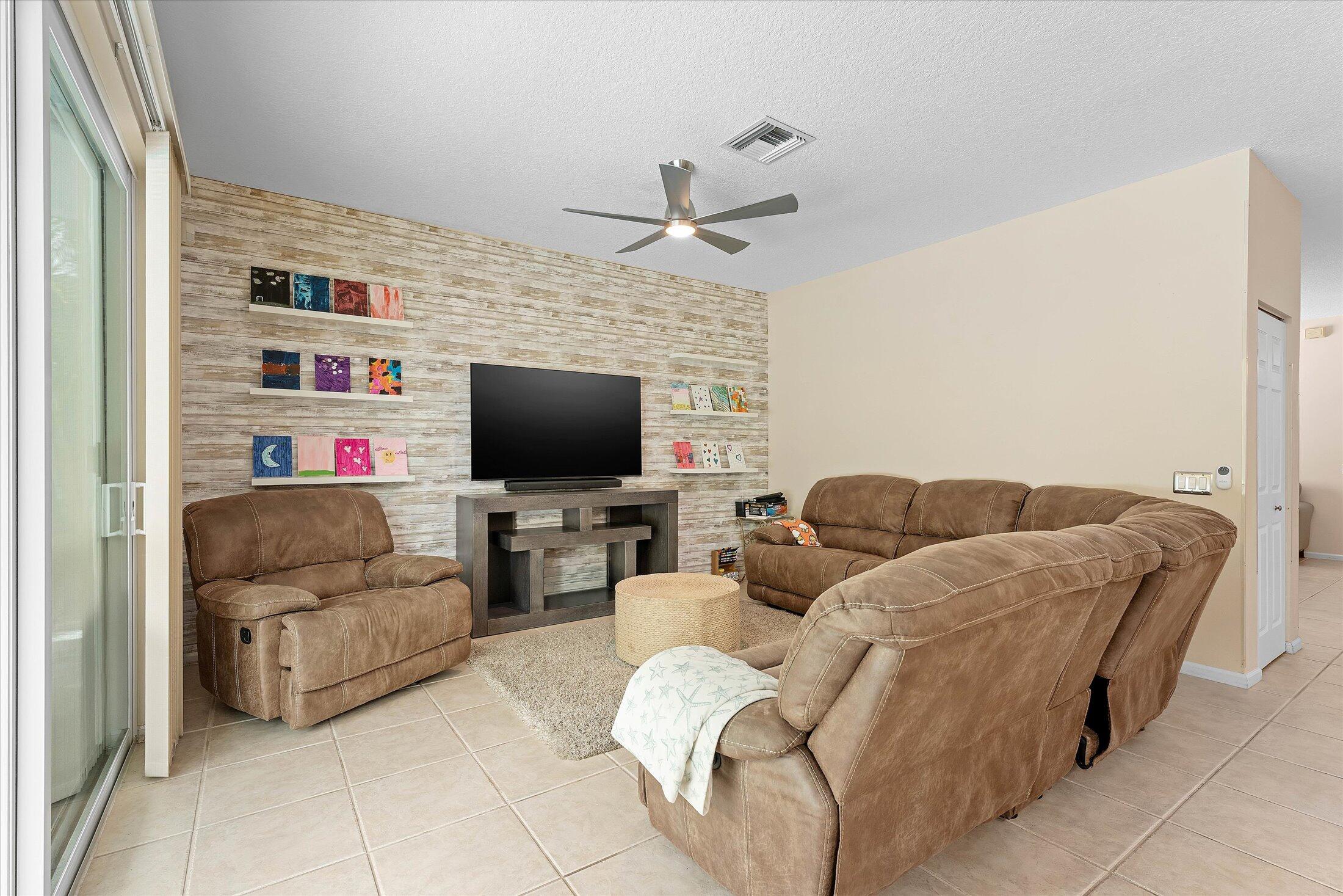 7061 Chesapeake Circle Boynton Beach, FL 33436 - Photo 15 of 51 a living room with furniture and a flat screen tv