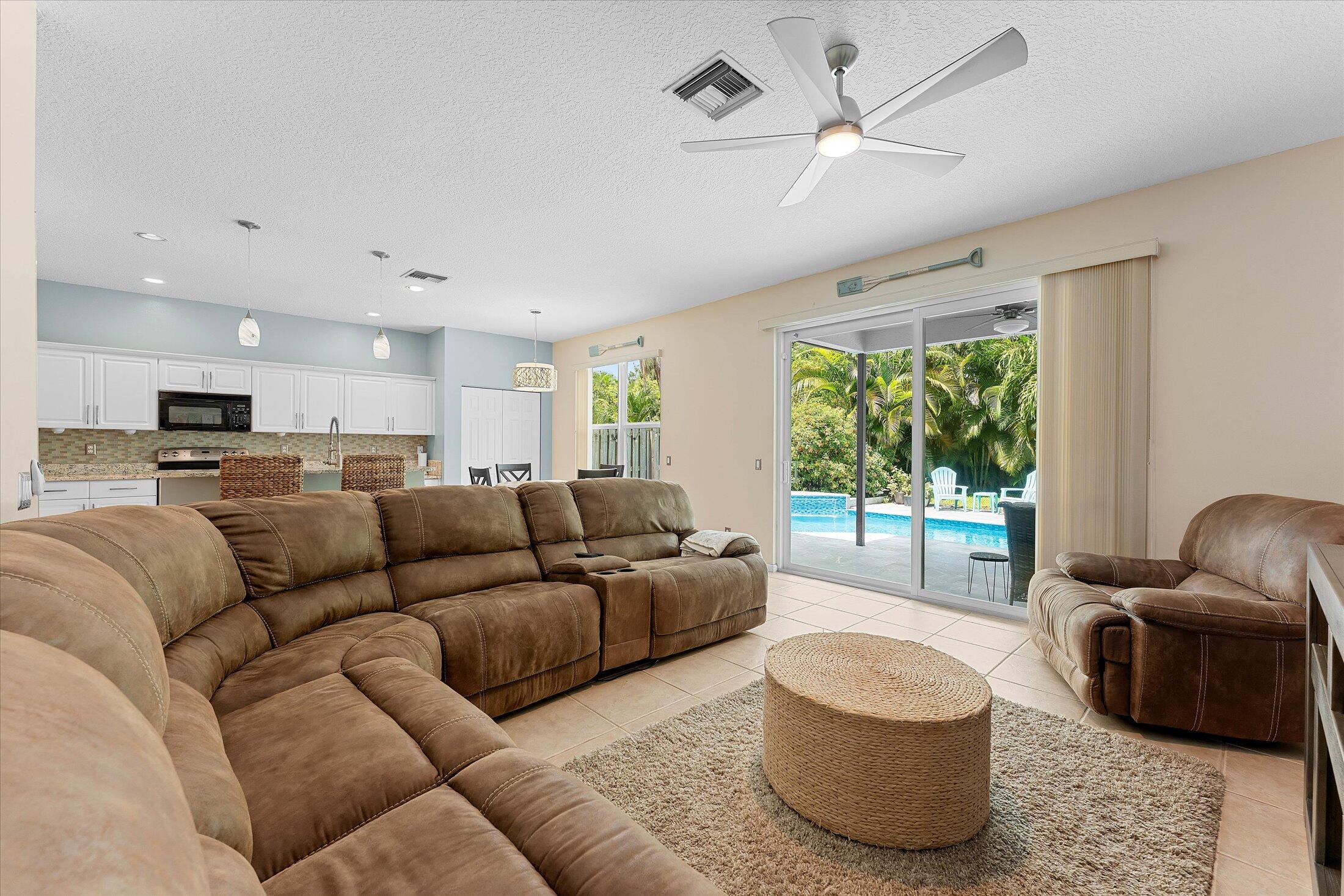 7061 Chesapeake Circle Boynton Beach, FL 33436 - Photo 16 of 51 a living room with furniture and a large window with wooden floor