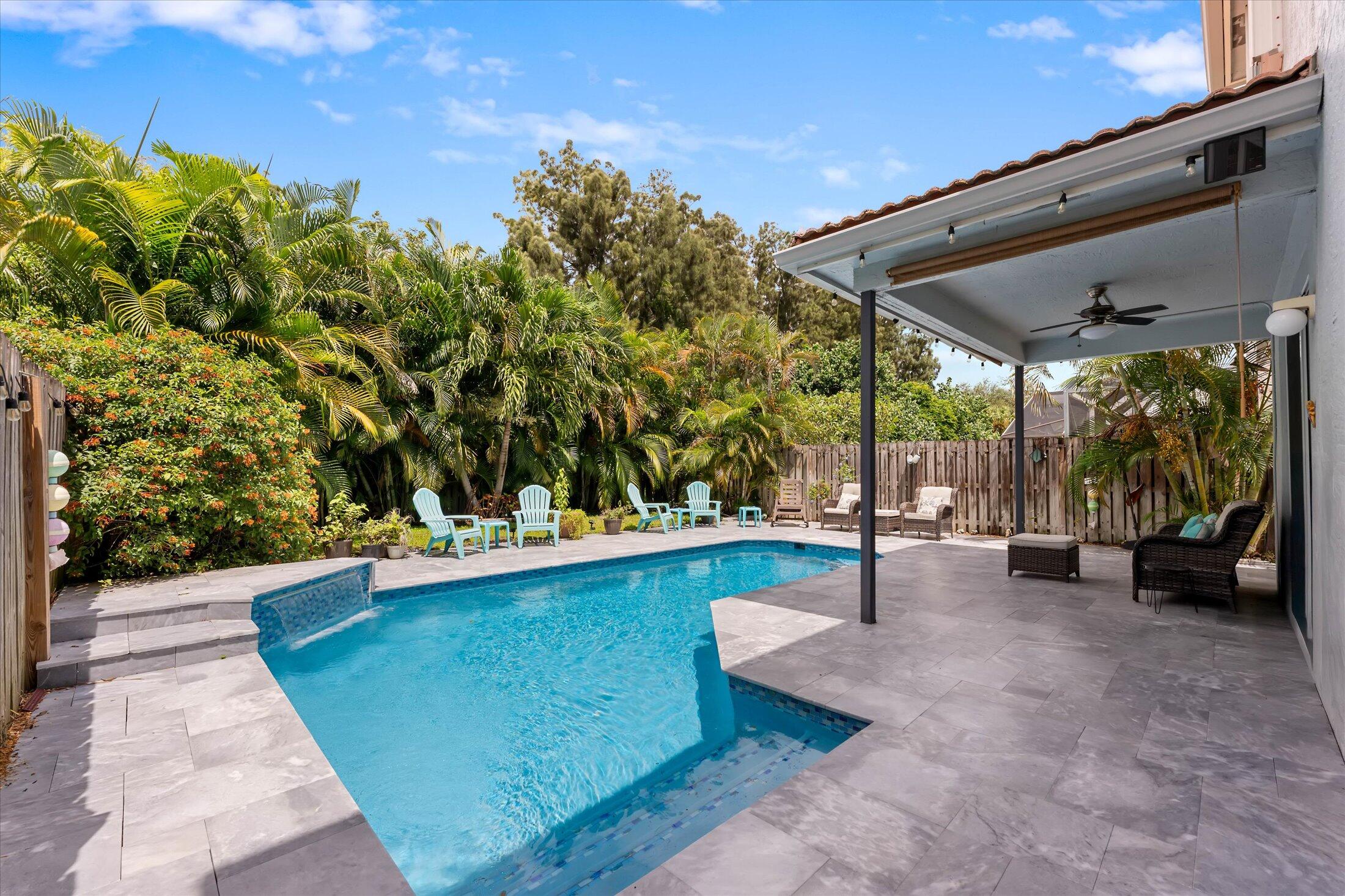 7061 Chesapeake Circle Boynton Beach, FL 33436 - Photo 17 of 51 a view of a patio with chairs and a yard