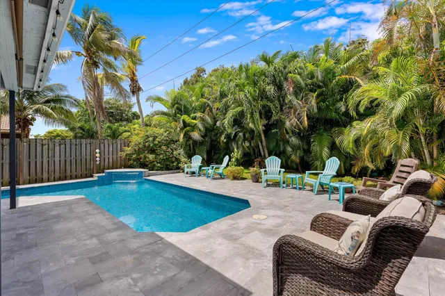 a view of a backyard with swimming pool