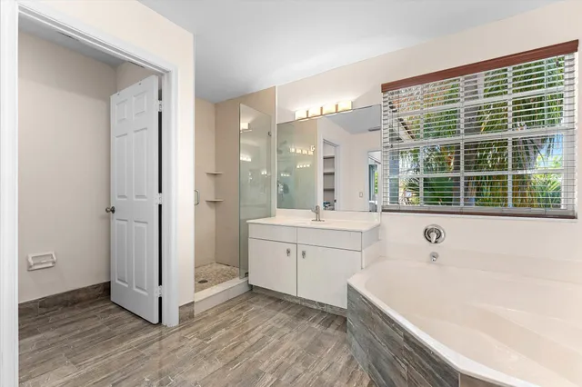 a spacious bathroom with a tub shower and sink