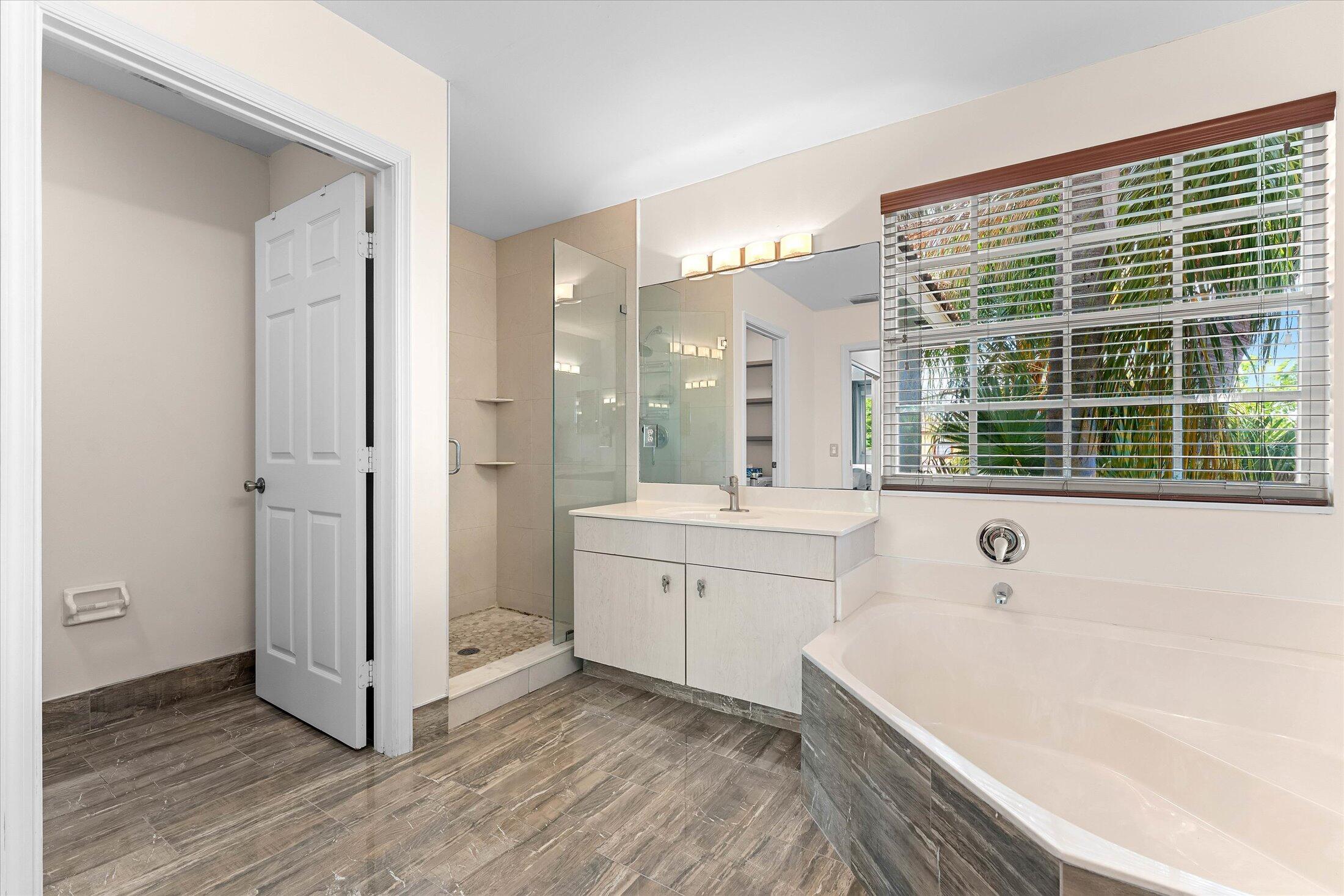 7061 Chesapeake Circle Boynton Beach, FL 33436 - Photo 30 of 51 a spacious bathroom with a tub shower and sink