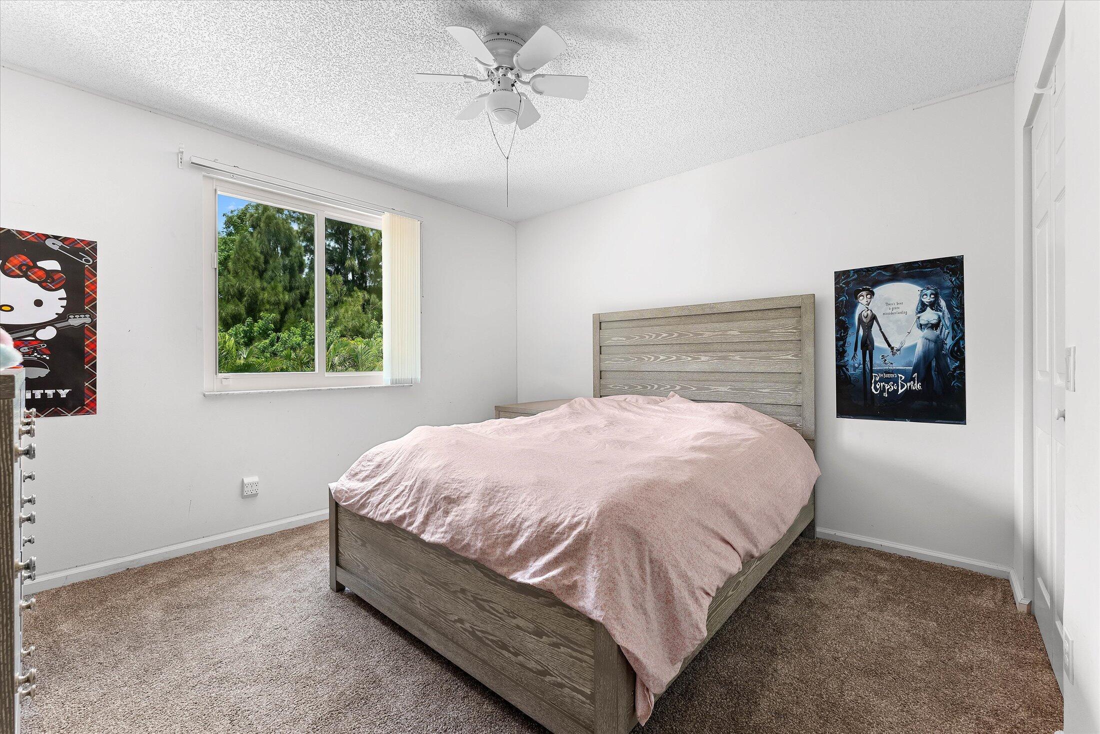 7061 Chesapeake Circle Boynton Beach, FL 33436 - Photo 37 of 51 a large bed sitting in a bedroom next to a window