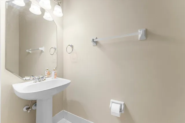 a bathroom with a sink a mirror and a shower