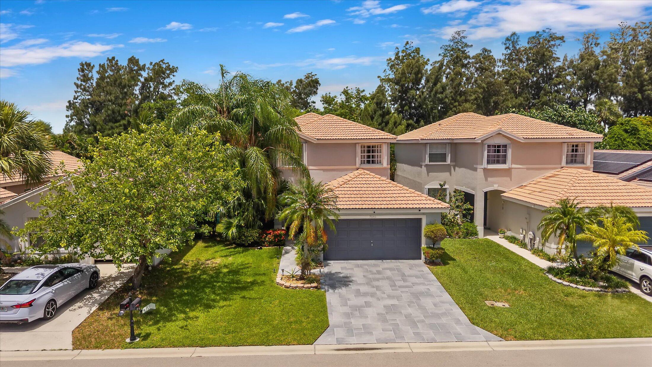 7061 Chesapeake Circle Boynton Beach, FL 33436 - Photo 40 of 51 a front view of a house with a yard