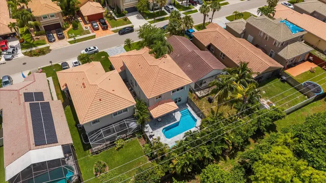 an aerial view of a house with a garden and trees