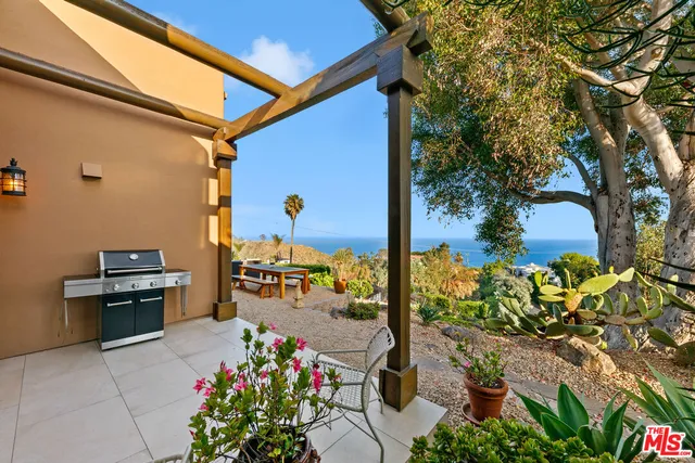 a kitchen with stainless steel appliances kitchen island granite countertop a refrigerator a stove and a sink