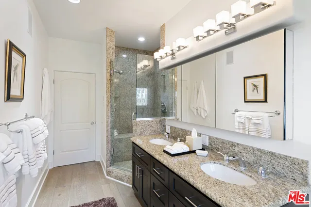 a living room with furniture large window and potted plants
