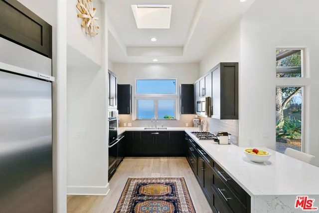 a kitchen with a sink and a stove top oven