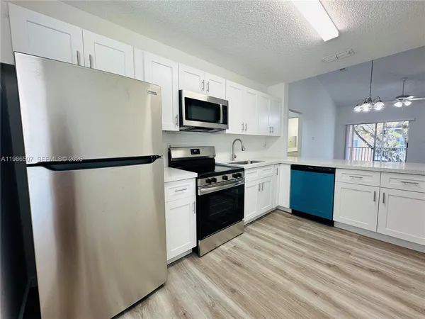 a kitchen with a refrigerator sink and cabinets
