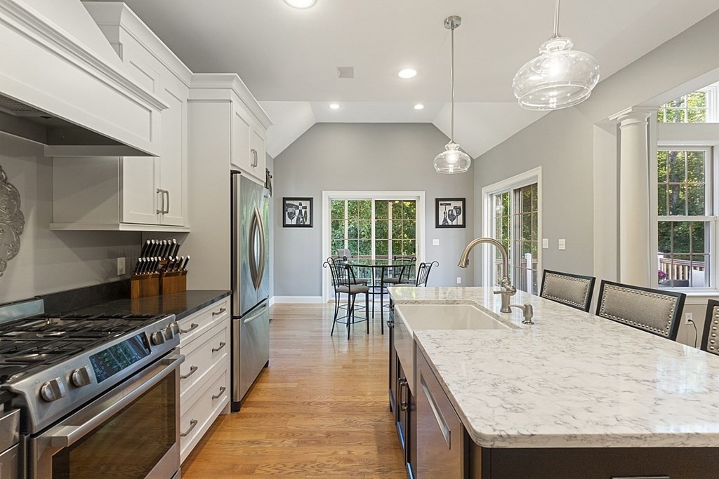 3 Squareshire Road Sterling, MA 01564 - Photo 13 of 42 a large kitchen with granite countertop a stove dining table chairs and a large window