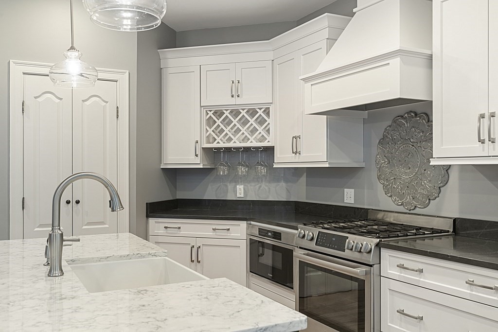 3 Squareshire Road Sterling, MA 01564 - Photo 16 of 42 a kitchen with granite countertop a stove a sink and a microwave