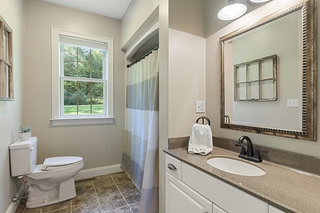 3 Squareshire Road Sterling, MA 01564 - Photo 26 of 42 a bathroom with a granite countertop sink toilet a mirror and window