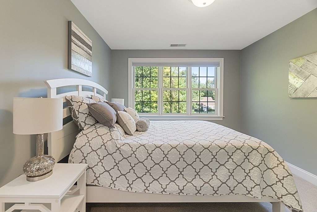 3 Squareshire Road Sterling, MA 01564 - Photo 29 of 42 a large bed sitting in a bedroom next to a window with lamp