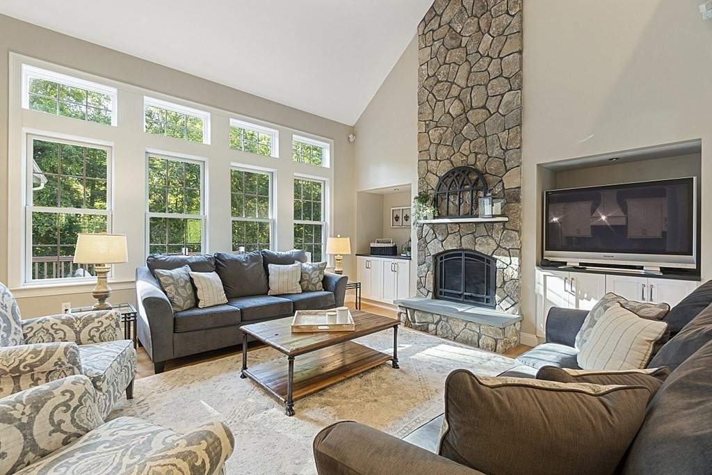 3 Squareshire Road Sterling, MA 01564 - Photo 9 of 42 a living room with furniture a flat screen tv and a fireplace
