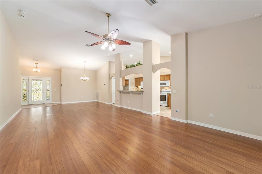 16369 Southwest 14th Avenue Road Ocala, FL 34473 - Photo 12 of 49 a view of an empty room with window and wooden floor