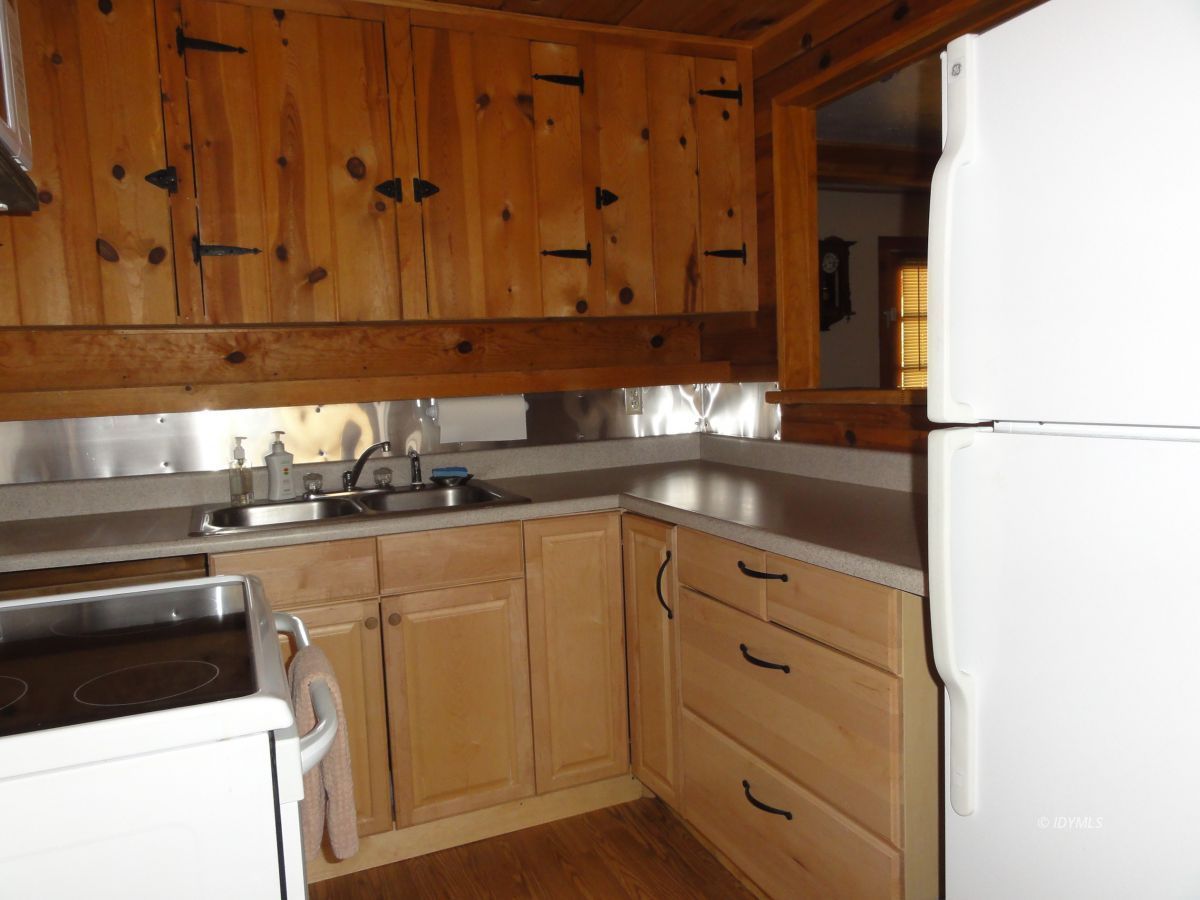 24810 Old Banning Road Idyllwild, CA 92549 - Photo 14 of 22 a kitchen with granite countertop cabinets stainless steel appliances and a counter space