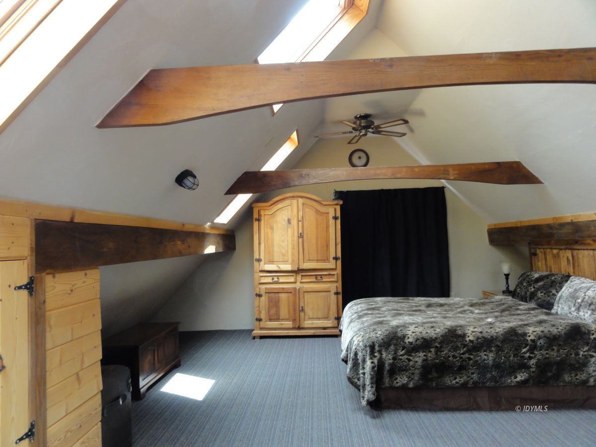 24810 Old Banning Road Idyllwild, CA 92549 - Photo 17 of 22 a bedroom with a bed and a ceiling fan