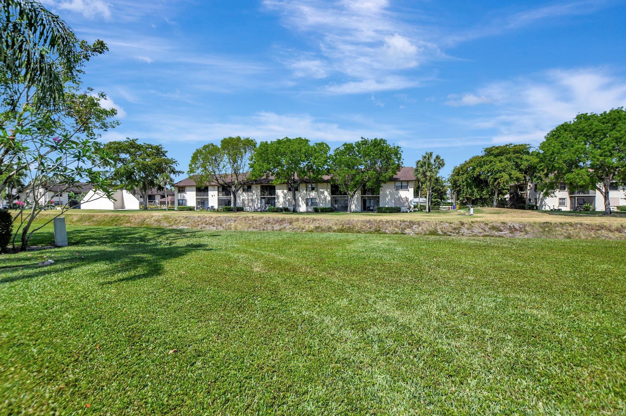 23359 Southwest 55th Way, Unit H Boca Raton, FL 33433 - Photo 35 of 41 back of townhome green area