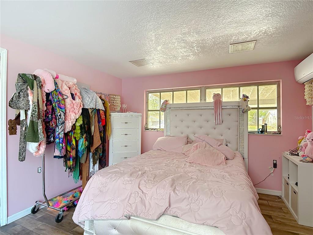 5433 Front Drive Holiday, FL 34690 - Photo 30 of 68 a large bedroom with a bed and a large window