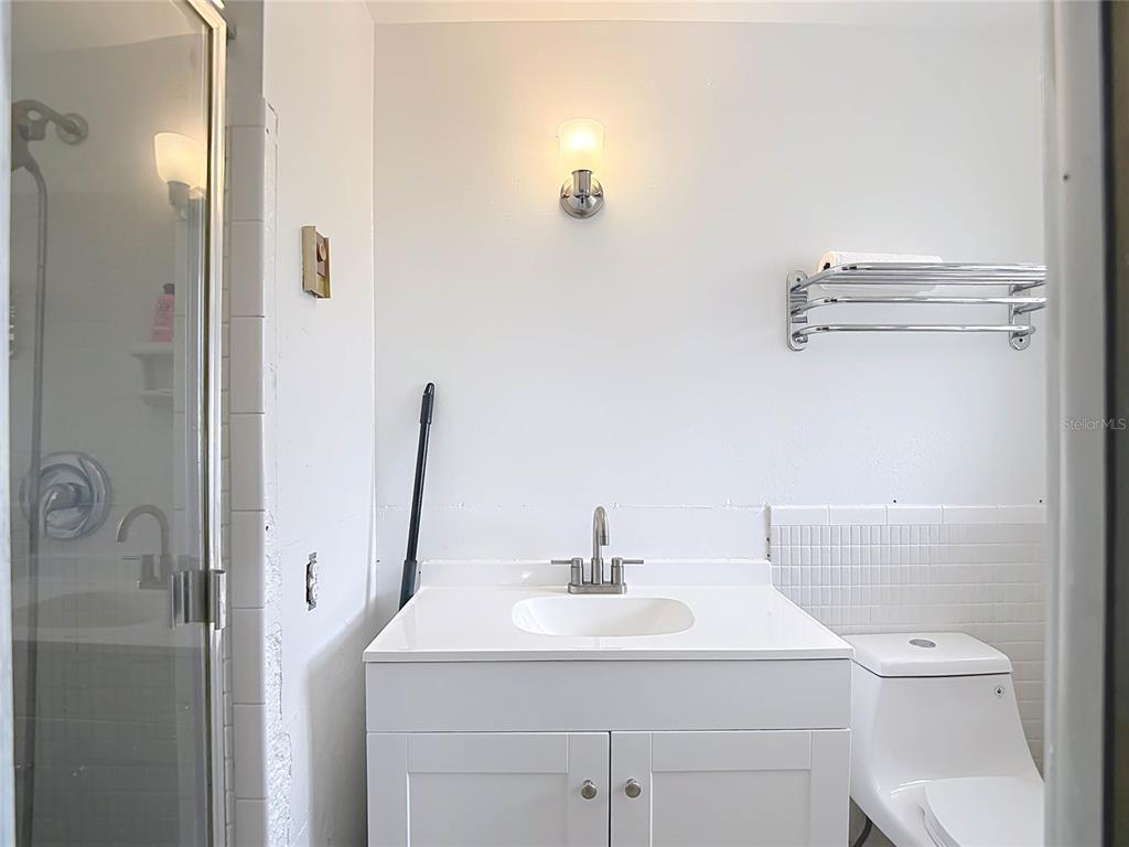 5433 Front Drive Holiday, FL 34690 - Photo 38 of 68 a bathroom with a sink a toilet and mirror