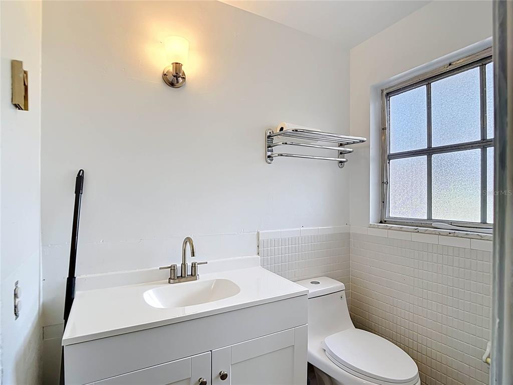 5433 Front Drive Holiday, FL 34690 - Photo 39 of 68 a bathroom with a toilet sink and mirror