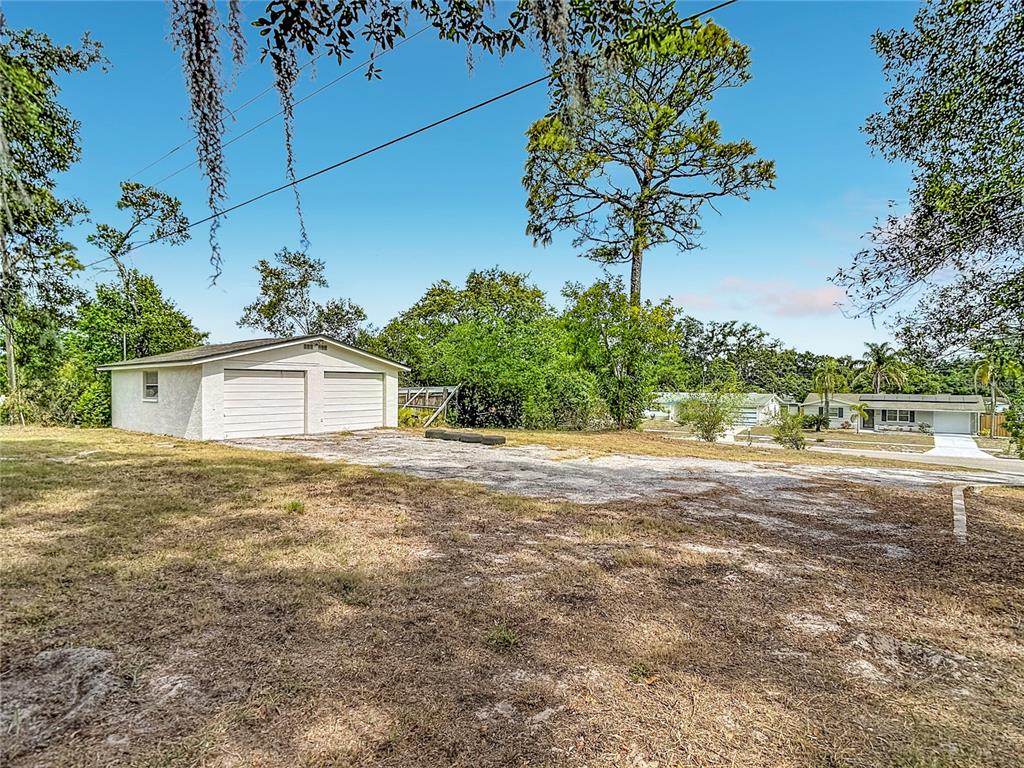 5433 Front Drive Holiday, FL 34690 - Photo 62 of 68 a view of a house with a yard and a garage