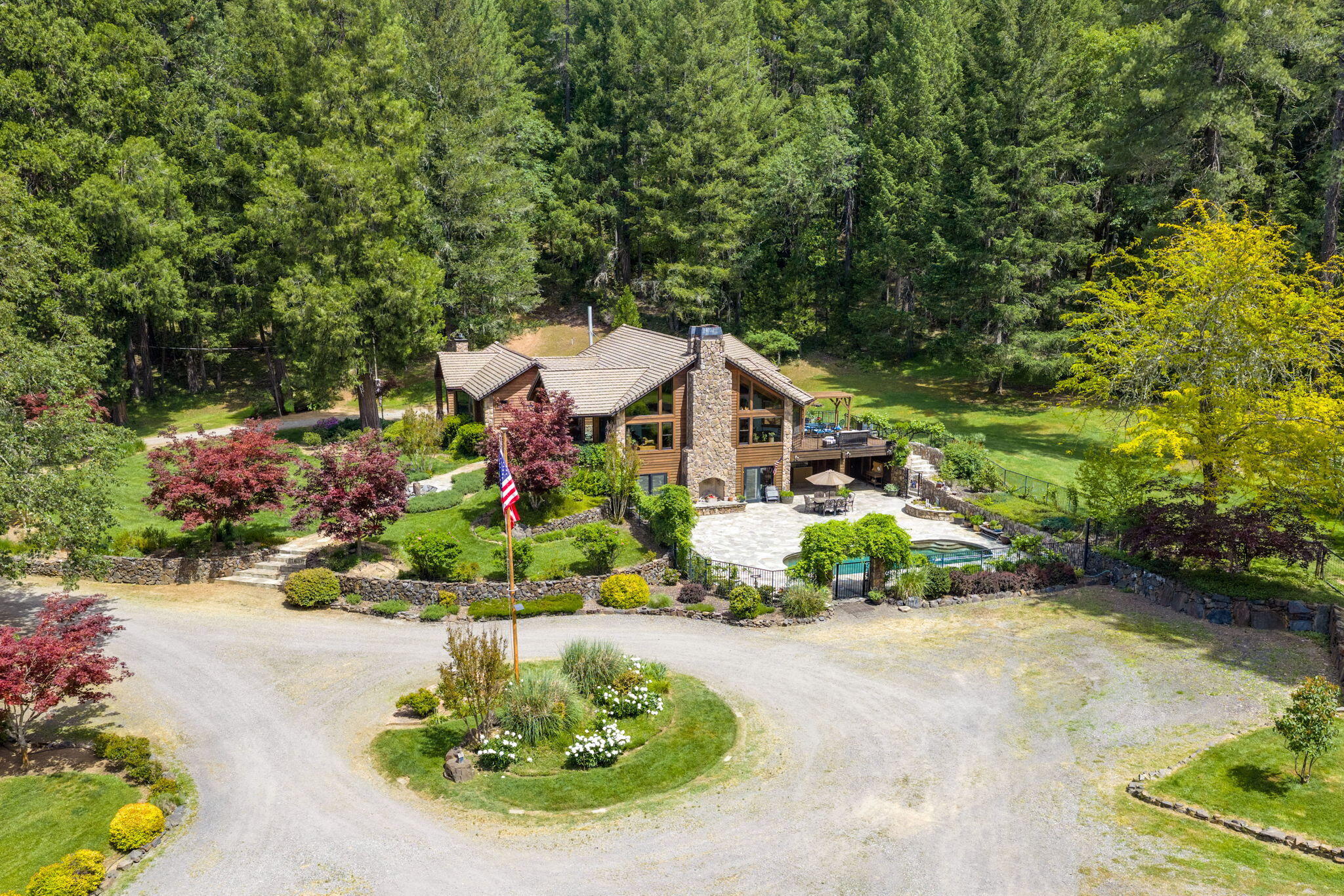 985 Elliott Creek Road Wilderville, OR 97543 - Photo 90 of 98 a front view of a house with a yard and outdoor seating