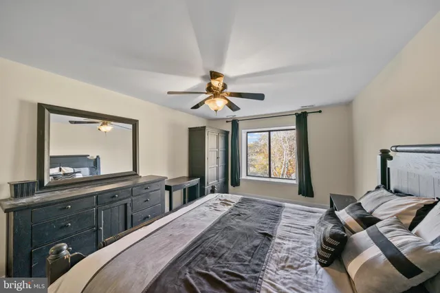 a bedroom with a large bed and a large window