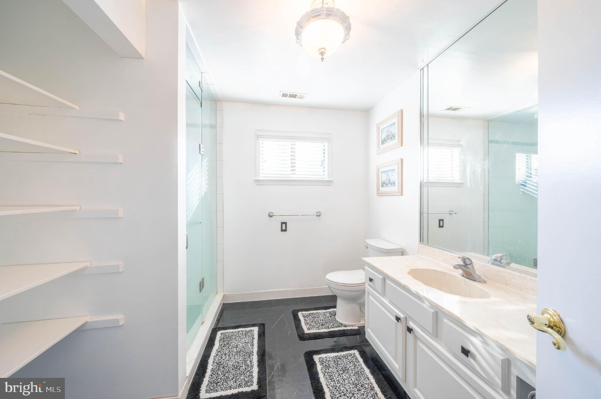 3604B Chadbury Road Mount Laurel, NJ 08054 - Photo 13 of 28 a bathroom with a double vanity sink a toilet and a mirror