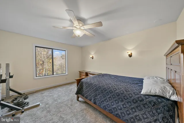 a bedroom with a bed window and dresser