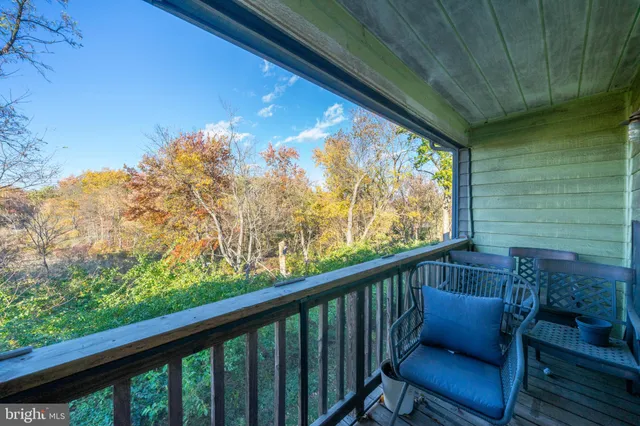 a balcony with wooden floor in outdoor space