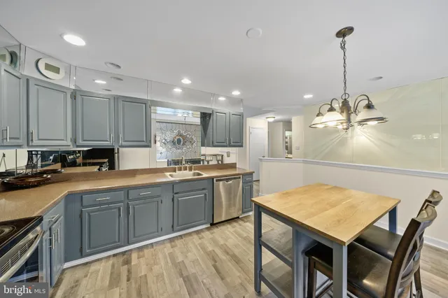 a kitchen with a table chairs sink and cabinets