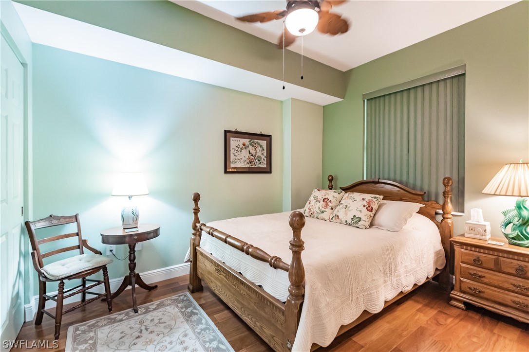 2797 First Street, Unit 403 Fort Myers, FL 33916 - Photo 13 of 33 a bedroom with a bed and a lamp on table