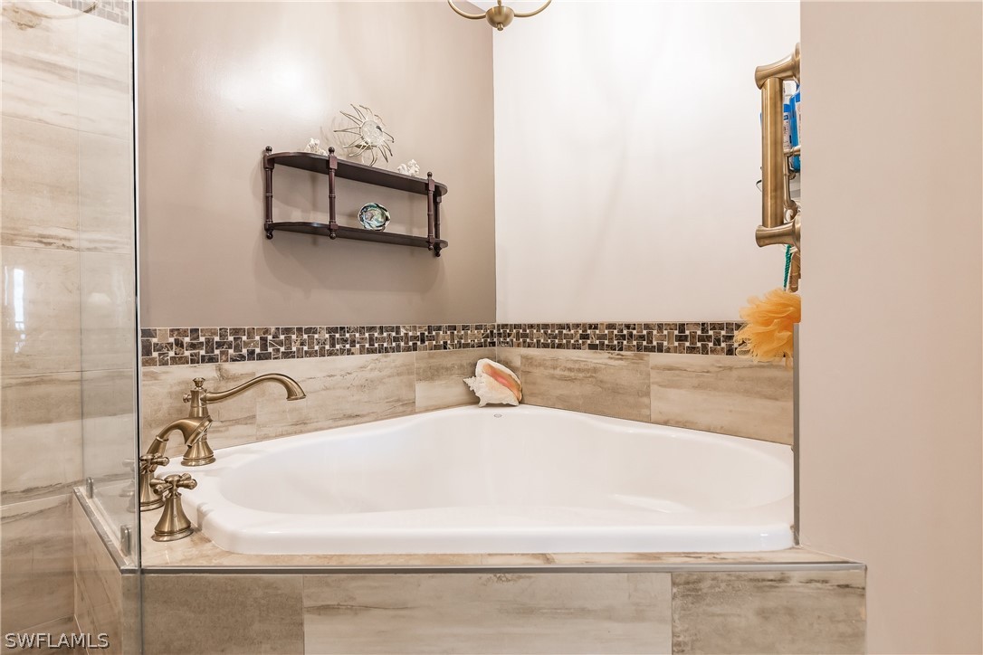 2797 First Street, Unit 403 Fort Myers, FL 33916 - Photo 22 of 33 a bathroom with a bathtub and a mirror