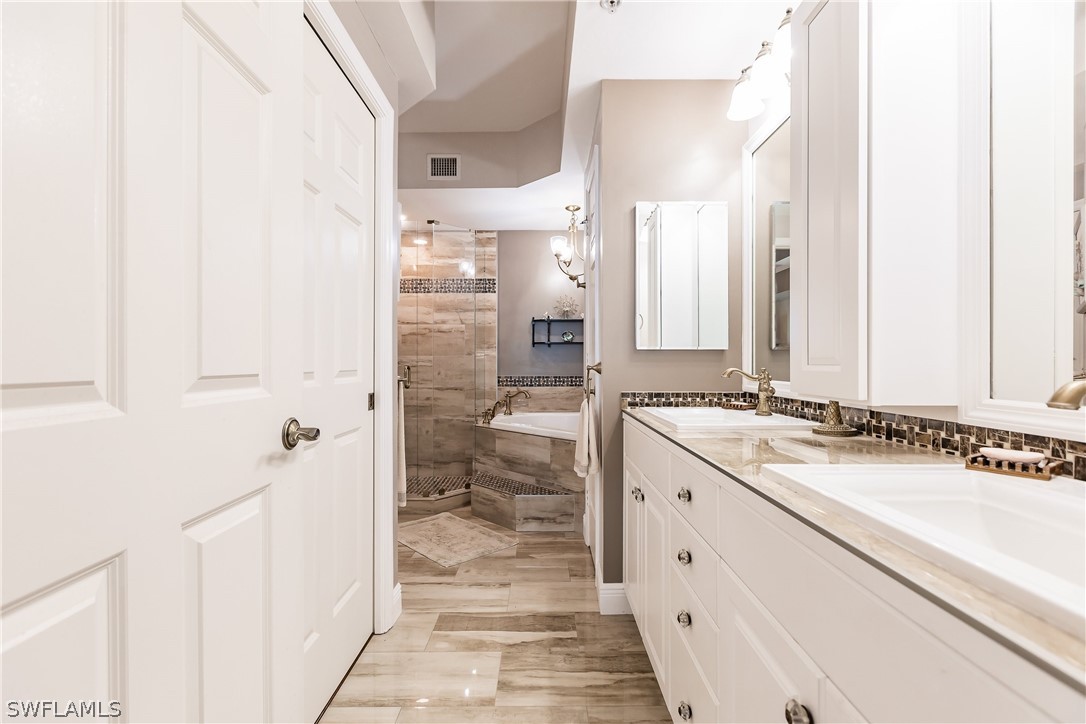 2797 First Street, Unit 403 Fort Myers, FL 33916 - Photo 23 of 33 a spacious bathroom with a granite countertop sink and a mirror