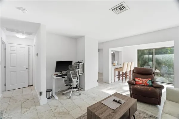 a view of a livingroom with workspace and a couch