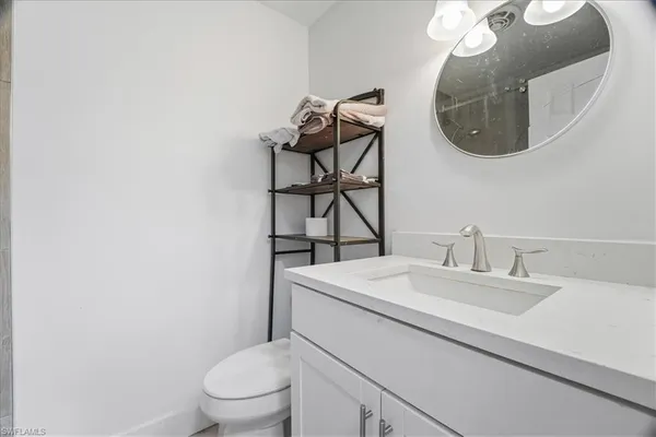 a bathroom with a sink vanity and toilet