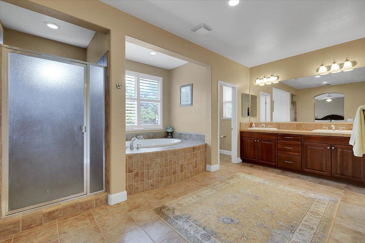 10022 Spring View Way Elk Grove, CA 95757 - Photo 42 of 54 a large bathroom with a large tub sink shower and mirror