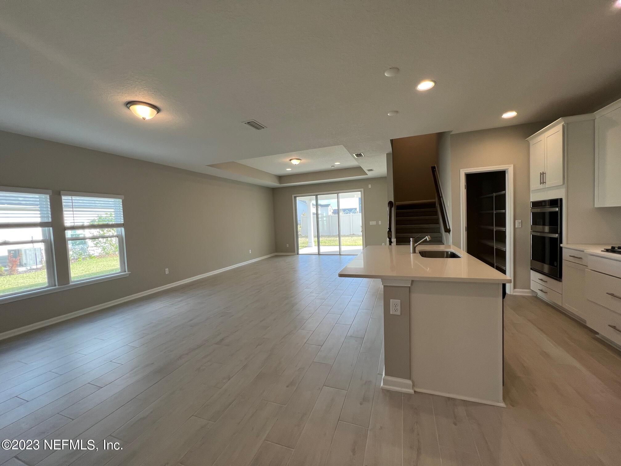 63 Yardley Ct Street St. Augustine, FL 32092 - Photo 4 of 54 an empty room with wooden floor and windows