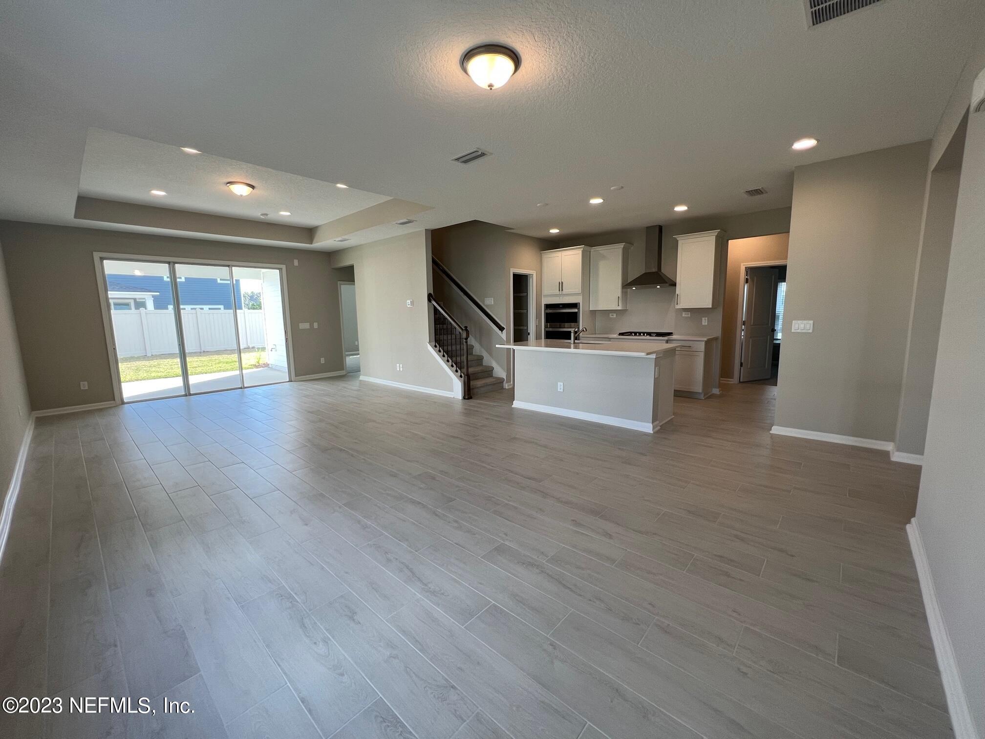 63 Yardley Ct Street St. Augustine, FL 32092 - Photo 5 of 54 a view of a living room and kitchen with furniture and wooden floor