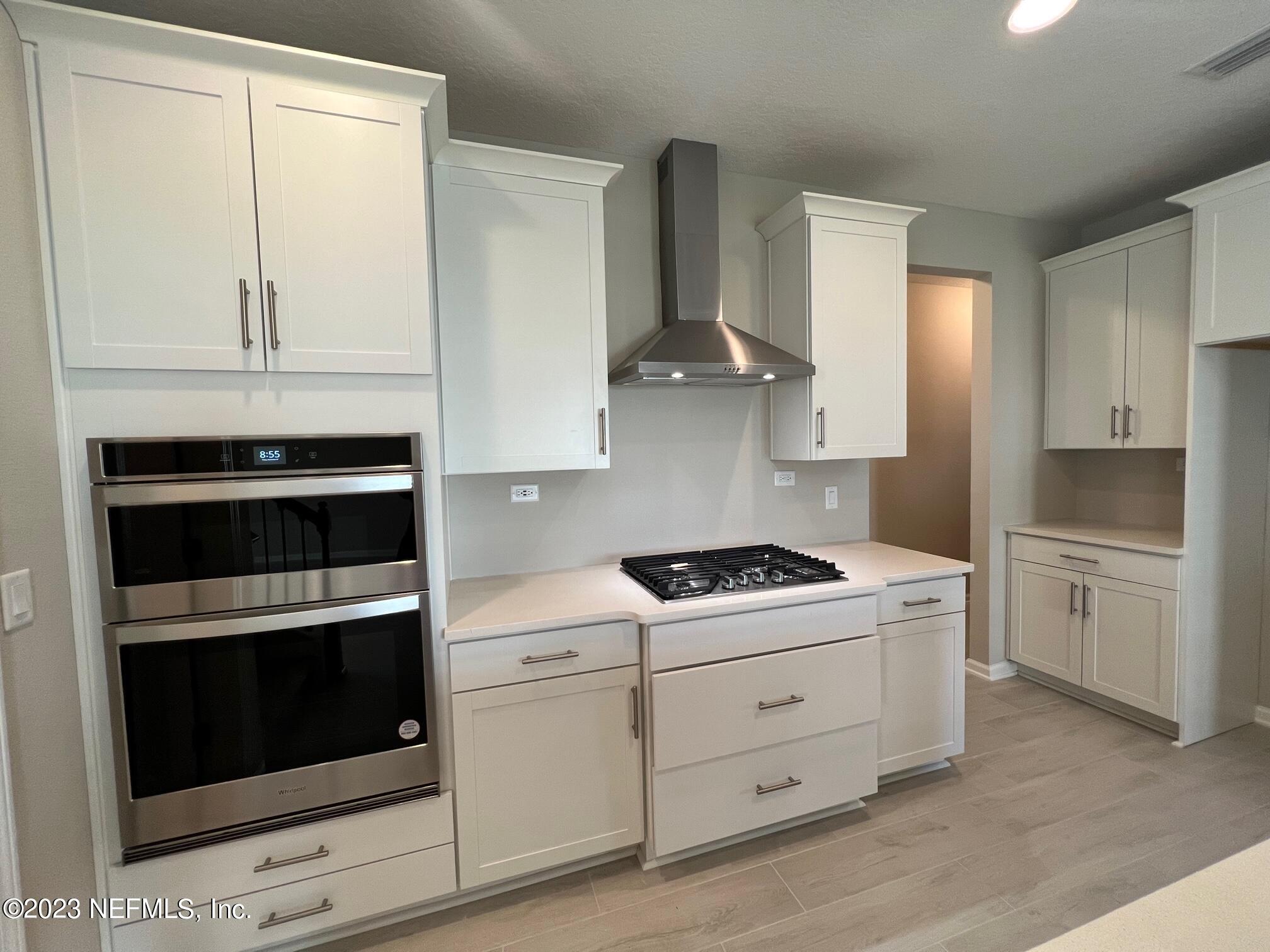 63 Yardley Ct Street St. Augustine, FL 32092 - Photo 6 of 54 a kitchen with stainless steel appliances white cabinets and a stove a oven with white countertops