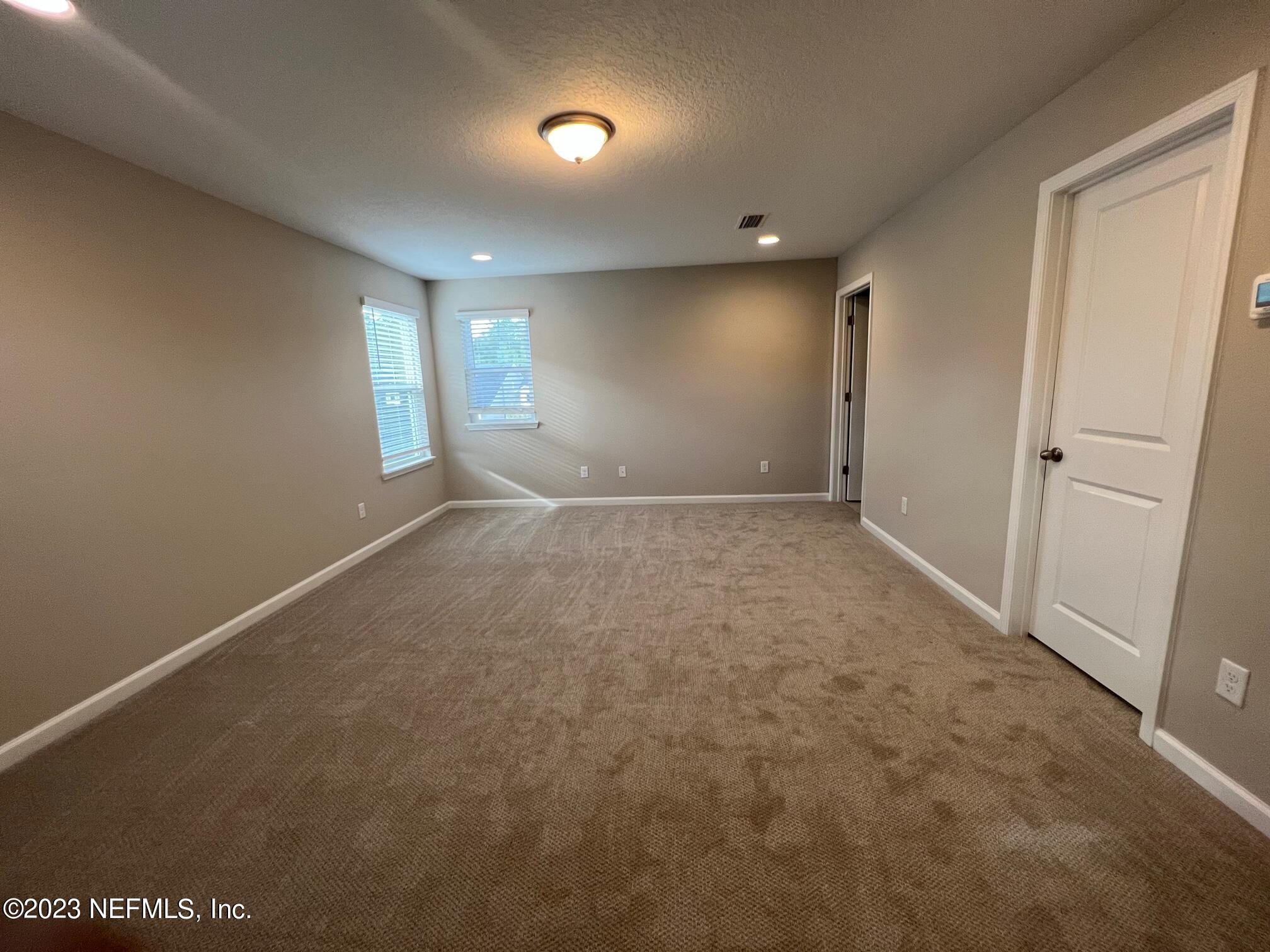 63 Yardley Ct Street St. Augustine, FL 32092 - Photo 10 of 54 an empty room with windows and closet
