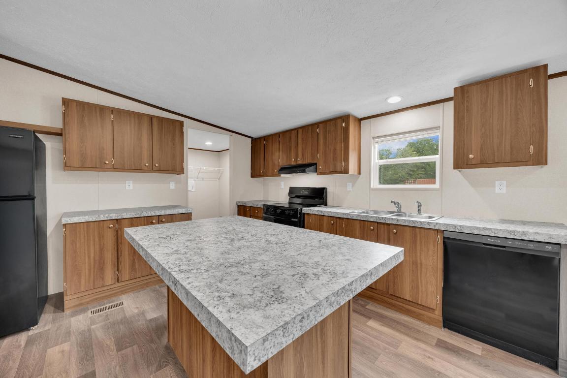 Tbd Overhill Road Bastrop, TX 78602 - Photo 17 of 37 a kitchen with a stove a sink a microwave and wooden cabinets
