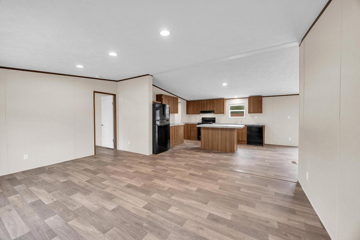 Tbd Overhill Road Bastrop, TX 78602 - Photo 34 of 37 a large white kitchen with kitchen island a stove a refrigerator a sink dishwasher with a dining table and chairs