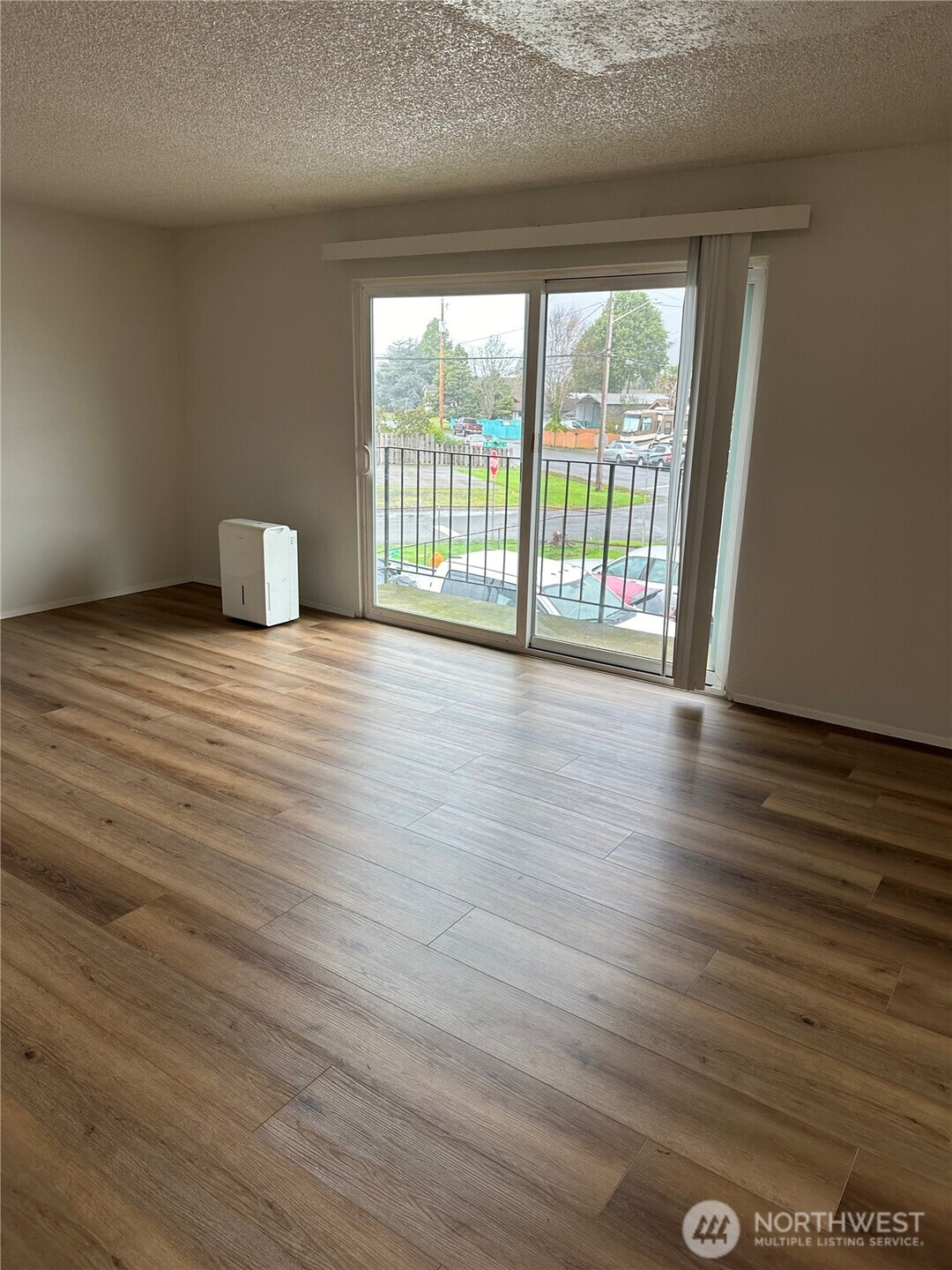 1111 West Market Street Aberdeen, WA 98520 - Photo 2 of 40 a view of an empty room with wooden floor and a window