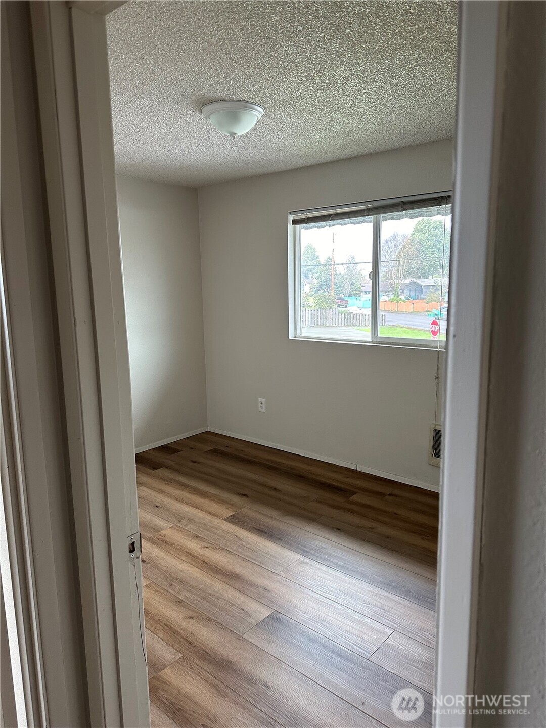 1111 West Market Street Aberdeen, WA 98520 - Photo 4 of 40 a view of empty room with wooden floor and fan